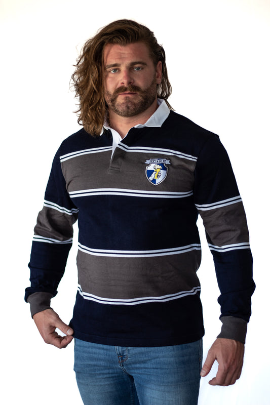 A man wearing a blue and grey rugby shirt with sociable crest