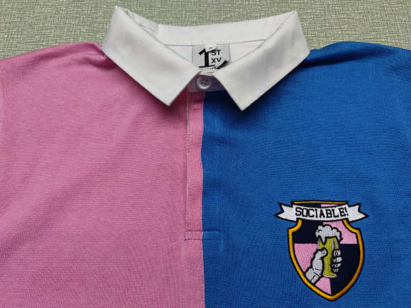 The collar and sociable crest of the Sour sociable rugby shirt
